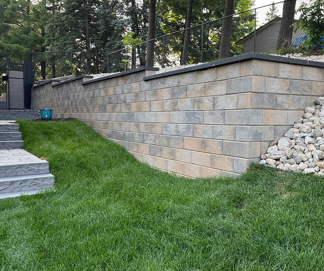 Finished block retaining wall with stone steps and landscaped cottage grounds