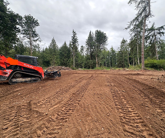Skid steer grading and preparing a property